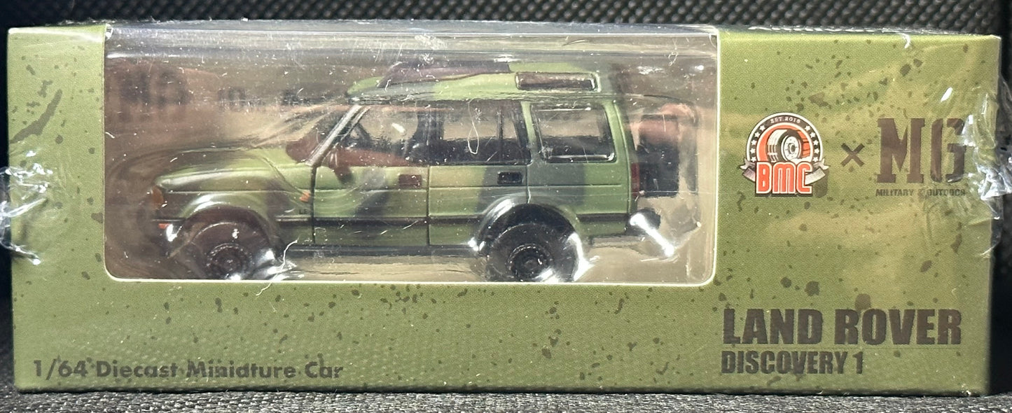 BM CREATIONS JUNIOR 1/64 Land Rover 1998 Discovery 1 Military Camouflage with Oil Tank (MG Edition) RHD