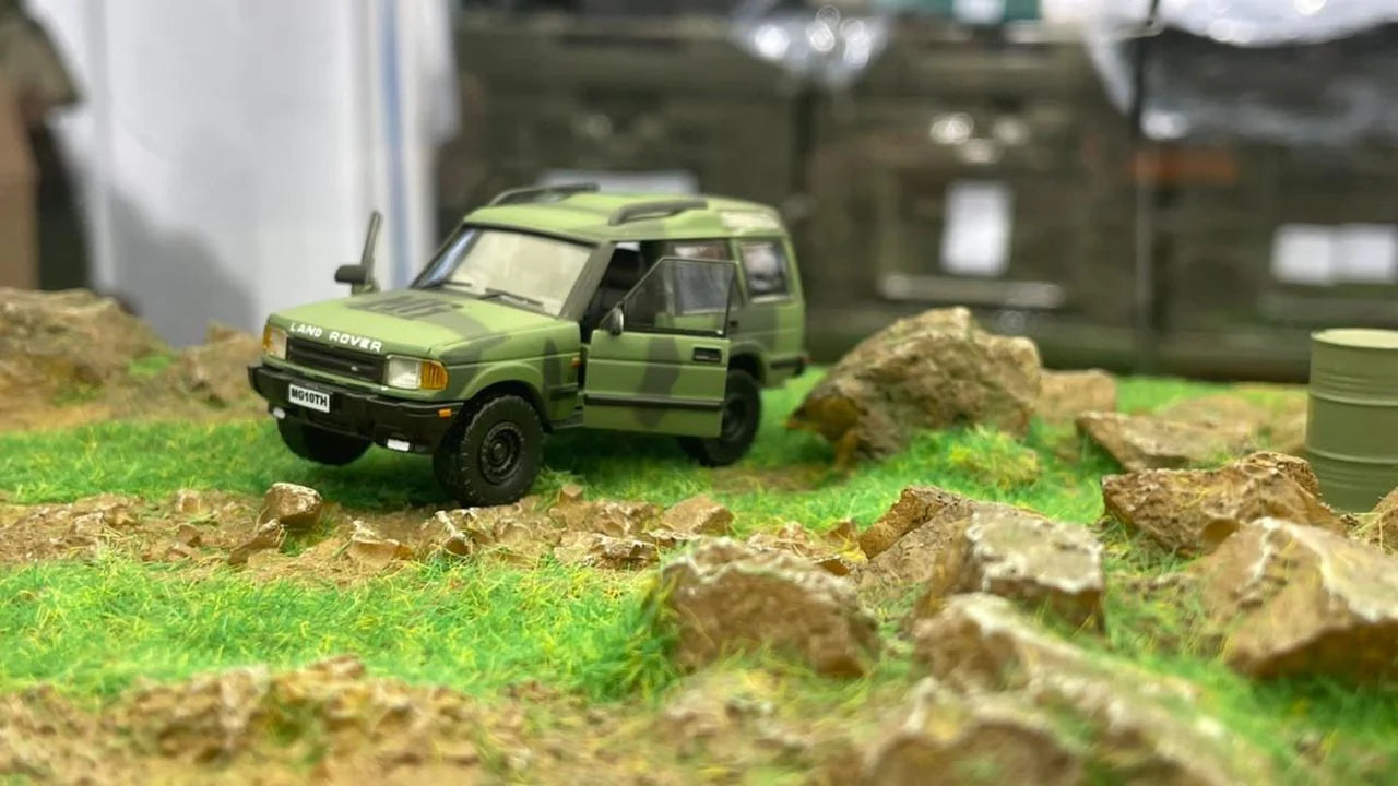 BM CREATIONS JUNIOR 1/64 Land Rover 1998 Discovery 1 Military Camouflage with Oil Tank (MG Edition) RHD