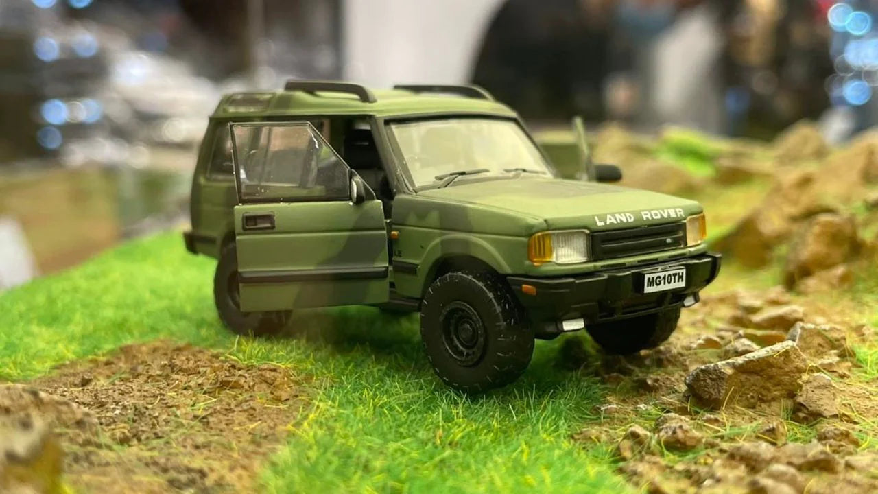 BM CREATIONS JUNIOR 1/64 Land Rover 1998 Discovery 1 Military Camouflage with Oil Tank (MG Edition) RHD