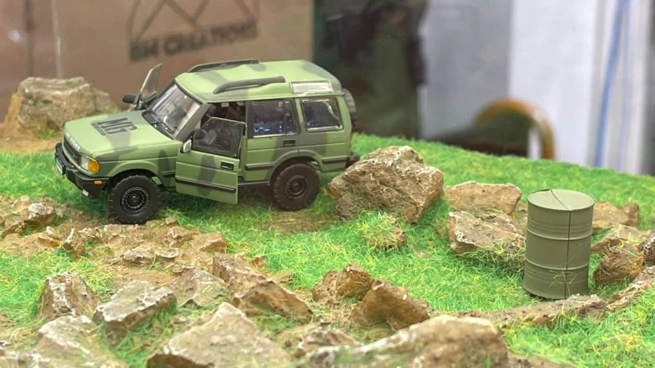 BM CREATIONS JUNIOR 1/64 Land Rover 1998 Discovery 1 Military Camouflage with Oil Tank (MG Edition) RHD